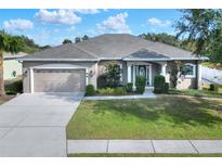 One-story home with a large front yard, attached garage, and attractive landscaping at 4756 Acorn Dr, Mulberry, FL 33860