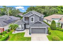 Two-story house with gray exterior and a two-car garage at 6857 Eagle Ridge Loop, Lakeland, FL 33813