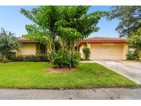 Single story home with lush landscaping and attached garage at 1001 Rolling Woods Ln, Lakeland, FL 33813