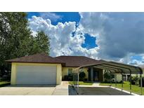 Single-story home with attached garage and carport at 180 Lakeview Dr, Haines City, FL 33844