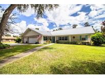 One-story home with metal roof and landscaped yard at 310 Willow Oak Ct, Fort Meade, FL 33841