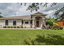 Single-story home with landscaped yard at 1619 Prairie Blossom Dr, Lakeland, FL 33810