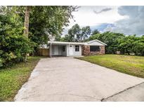 Brick ranch house with carport and large lawn at 415 Lucille St, Bartow, FL 33830