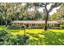Ranch home showcasing a spacious lawn and lush landscaping at 7525 Catherine Dr, Lakeland, FL 33810