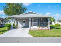 Cozy single-story home with carport and screened porch at 4829 Colonnades E Cir, Lakeland, FL 33811