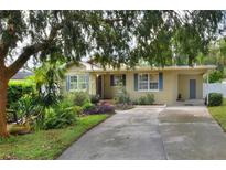 Front view of charming ranch house with mature landscaping at 1819 Meadowbrook Ave, Lakeland, FL 33803