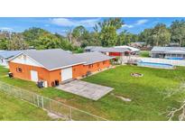 Aerial view of house, detached garage, large backyard, and pool at 4390 Sunnyside Dr, Lakeland, FL 33810