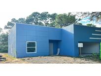 Newly constructed home with blue exterior and a modern design at 2626 Magnolia Cir, Lake Wales, FL 33898