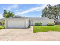 Single story home with attached garage and manicured lawn at 2233 20Th Nw St, Winter Haven, FL 33881