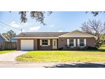 House exterior with a white garage door and front yard at 3933 Strickland Ct, Lakeland, FL 33812