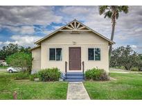 Quaint bungalow home with front yard and walkway at 433 Main St, Lake Hamilton, FL 33851