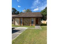 Single story house with stone accents and a brown roof at 5009 Cimarron Dr, Lakeland, FL 33813