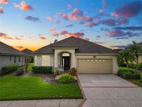 One-story home with a two-car garage and landscaped yard at 2356 Lake James Way, Lakeland, FL 33810