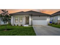 Charming one-story home with a two-car garage and well-manicured lawn at 1419 S Lincoln Ave, Lakeland, FL 33803