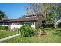 Landscaped yard with walkway to charming house entrance at 17 Loma Verde # 17, Lakeland, FL 33813