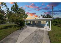 House exterior at dusk with carport at 1220 Woodland Ave, Lakeland, FL 33801