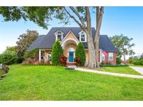 Two-story house with a charming front porch and landscaping at 5009 Hanover Ln, Lakeland, FL 33813