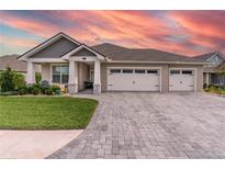 Two-story home with three-car garage and stone accents at 7929 Lake James Blvd, Lakeland, FL 33810