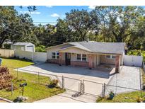 Brick home with a carport and paved driveway at 855 Candyce Ave, Lakeland, FL 33815