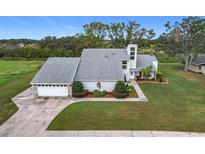 Two-story house with attached garage and landscaping at 92 Wood Hall Dr, Mulberry, FL 33860