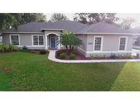 One-story home with landscaped yard at 10812 Versailles Blvd. Blvd, Clermont, FL 34711