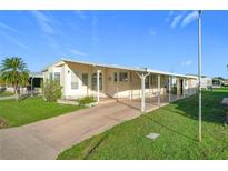 Single wide mobile home with carport at 6461 Hollyberry Ne Ln, Winter Haven, FL 33881