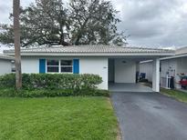 Inviting exterior of a single-story home with carport and landscaped lawn at 830 Imperial Blvd, Lakeland, FL 33803