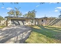 Ranch-style home with a two-car garage and fenced yard at 2650 Jungle St, Lakeland, FL 33801