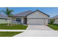 One-story home with a two-car garage and attractive landscaping at 4645 Grandview Glen Dr, Auburndale, FL 33823