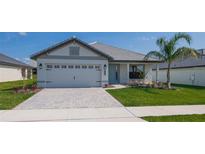 One-story home with gray siding, gray roof, and landscaping at 5108 Villa Crest Way, Auburndale, FL 33823