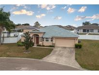 One-story home with a two-car garage and landscaped yard at 5791 Woodruff Way, Lakeland, FL 33812