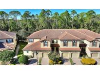 Aerial view of townhouses with tile roofs, two-car garages, and lush landscaping at 8205 Roseville, Davenport, FL 33896