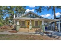 Charming house exterior, light green with yellow door at 902 Vistabula St, Lakeland, FL 33801