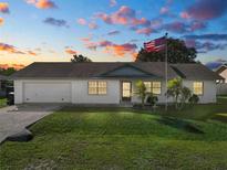 Single-story home with attached garage and a well-maintained lawn at 227 Ridgedale Dr, Lakeland, FL 33809