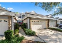Two-story townhome with attached two-car garage and landscaped walkway at 3164 Stonewater Dr # 3164, Lakeland, FL 33803