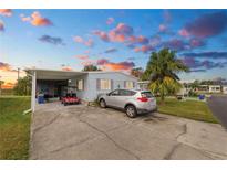 Mobile home with carport, golf cart, and driveway at 2055 S Floral Ave # 146, Bartow, FL 33830