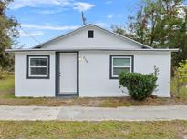 Newly renovated home features a white exterior, grey accents, and a well-maintained lawn at 515 S Charleston Ave, Fort Meade, FL 33841