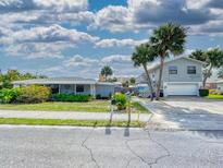 Charming two-story house with a two-car garage and tropical landscaping at 603 N Pine St, New Smyrna Beach, FL 32169