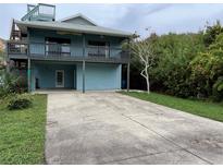 Two-story home with blue siding and spacious driveway at 6468 Engram Rd, New Smyrna Beach, FL 32169
