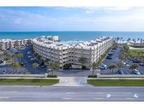 Oceanfront condo building with ample parking and tropical landscaping at 4501 S Atlantic Ave # 1210, New Smyrna Beach, FL 32169