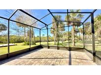 Spacious screened patio with paver floor and tranquil view of lush landscaping at 806 Pine Shores Cir, New Smyrna Beach, FL 32168