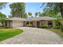 One-story home with brick facade and paver driveway at 1328 Needle Palm Dr, Edgewater, FL 32132