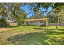 Charming single story home with a spacious lawn and mature trees at 923 S Myrtle Ave, New Smyrna Beach, FL 32168