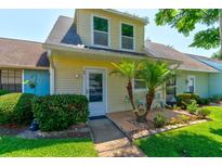 Attractive yellow house with a welcoming front entry and landscaping at 232 N Ridgewood Ave # G40, Edgewater, FL 32132