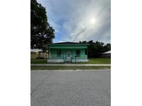 Quaint light green house with a front porch at 306 Sheldon St, New Smyrna Beach, FL 32168