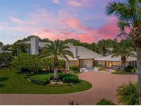 Luxury home with a metal roof, landscaping, and a brick driveway at 1006 S Riverside Dr, Edgewater, FL 32132