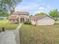 Two story home with a pool and detached garage at 299 W Hickory Ave, Oak Hill, FL 32759