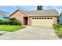 Charming single-story house with attached garage and landscaped yard at 790 Pine Shores Cir, New Smyrna Beach, FL 32168