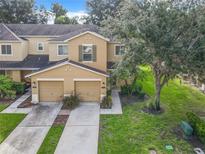 Two-story townhome with two-car garage and front yard at 521 Mount Olympus Blvd, New Smyrna Beach, FL 32168