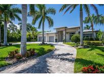 Luxury home with circular driveway and lush landscaping at 113 Via Benevento, New Smyrna Beach, FL 32169